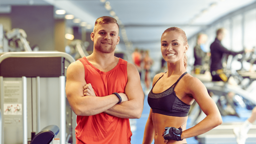 Fit Man And A Woman Posing At The Gym