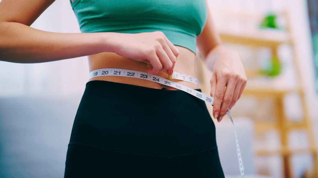 Woman measuring her weight loss