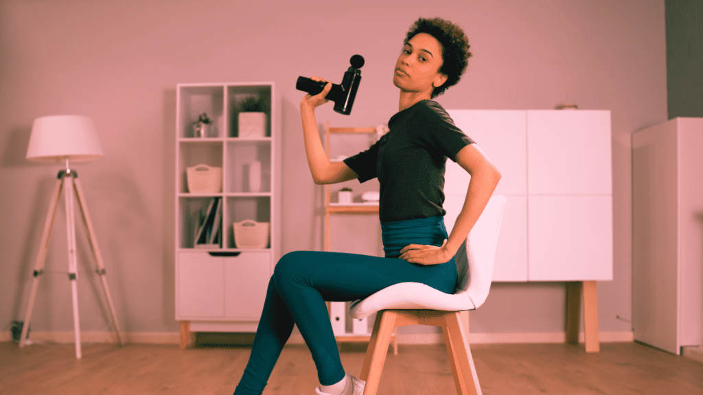 How to Use a Massage Gun: A Woman Posing With A Massage Gun 