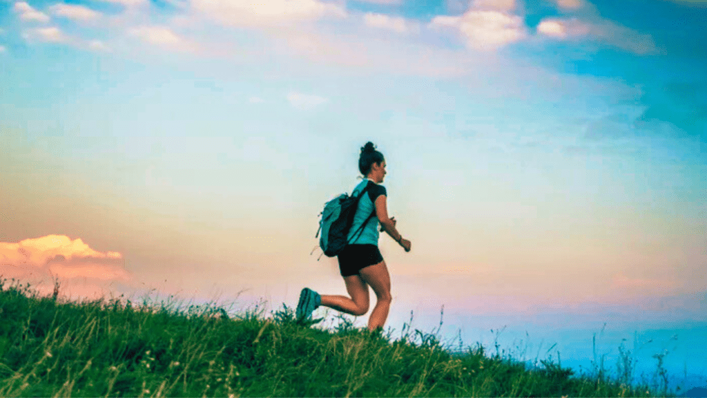 A Woman Training With A Back Bag On A Field 